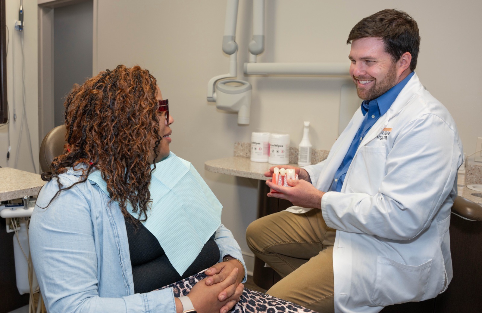 Dr. King explaining an implant model with a patient